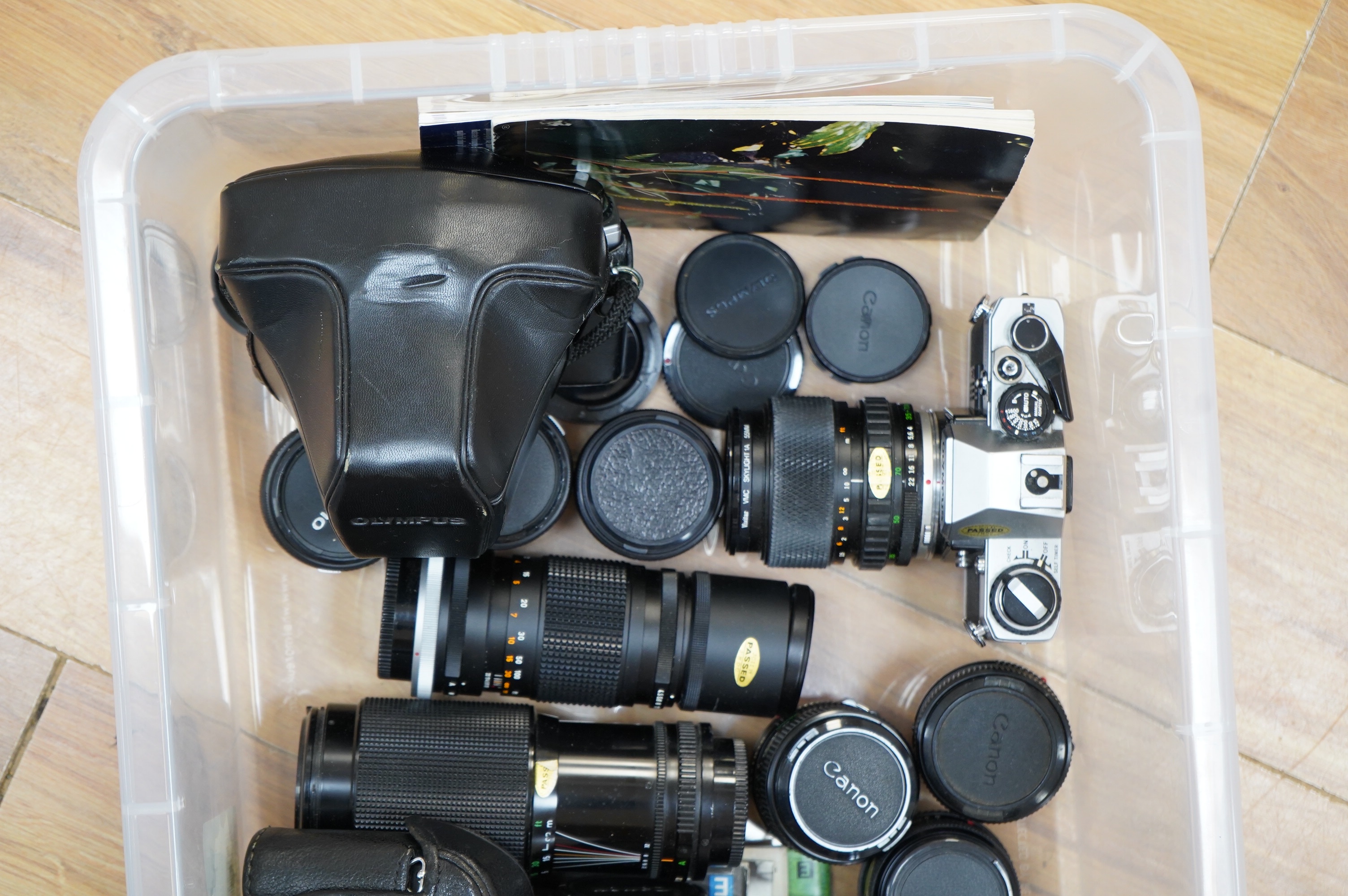 A quantity of various cameras and lenses to include Olympus, Minolta, Pentax and Canon. Condition - varies